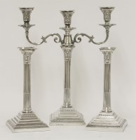 Lot 108 - A matched suite of silver three-branch candelabrum and a pair of candlesticks