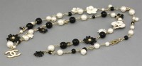 Lot 13 - A Chanel camellia black and white daisy pearl long necklace