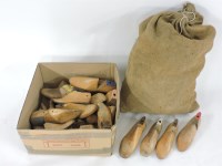 Lot 188 - A box and a stack of carved wooden shoe lasts