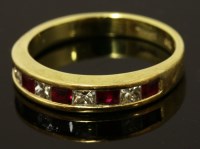 Lot 541 - A ruby and diamond half eternity ring