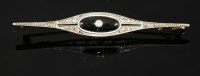 Lot 389 - An Art Deco onyx and diamond bar brooch