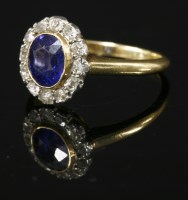 Lot 427 - An Edwardian sapphire and diamond oval cluster ring