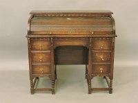 Lot 427 - An early 20th century oak roll top desk