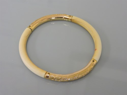 Lot 57 - A 19th century ivory slave bangle