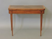 Lot 489 - A George III mahogany and satinwood fold over card table