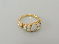 Lot 34 - A seven stone cabochon opal ring