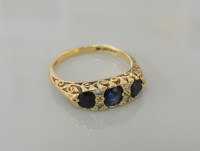 Lot 37 - An 18ct gold three stone sapphire ring