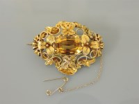 Lot 50 - An early Victorian oval cut citrine and filigree mounted brooch