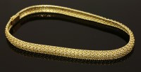 Lot 450 - A cased 18ct gold two-colour woven necklet by Cartier