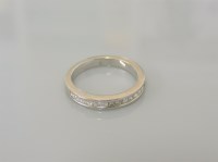 Lot 20A - A white gold princess cut diamond half eternity ring