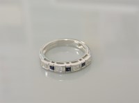 Lot 21A - An 18ct white gold sapphire and baguette cut diamond half eternity ring