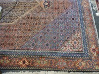 Lot 356 - A red ground wool carpet