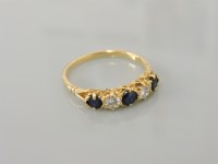 Lot 18 - A gold five stone sapphire and diamond ring