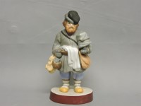 Lot 223 - A Russian Gardner Factory biscuit porcelain figure of a street vendor