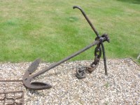 Lot 444 - A cast iron anchor and chain