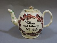 Lot 161 - A cream ware teapot