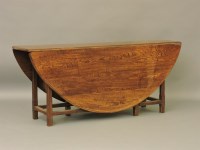 Lot 437 - An early to mid 20th century oak drop flap wake table