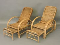 Lot 556 - A pair of bamboo and wicker adjustable reclining garden loungers