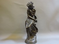Lot 292 - A bronzed female seated figure