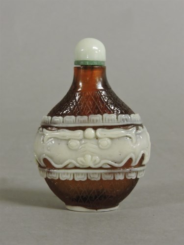 Lot 59 - A Chinese overlaid brown glass scent bottle and stopper