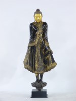 Lot 408 - A carved and painted standing Buddha