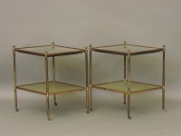 Lot 384 - A pair of two tier lacquered brass occasional tables
