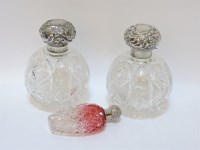 Lot 61 - A pair of cut glass and silver mounted scent bottles