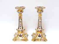 Lot 146 - A pair of Royal Crown Derby Imari decorated porcelain candlesticks