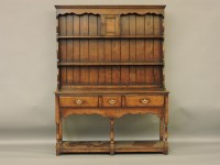 Lot 381 - A reproduction George III style oak dresser
