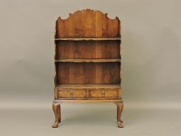 Lot 396 - A reproduction George III style walnut waterfall bookcase
