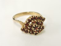 Lot 15 - A 9ct gold garnet crossover cluster ring