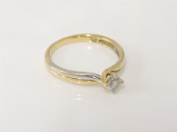 Lot 19 - An 18ct gold yellow and white gold single stone diamond crossover ring