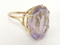 Lot 22 - A gold oval cut pale amethyst ring