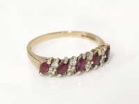 Lot 6 - A 9ct gold five stone diagonal marquise cut half hoop ruby ring