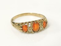 Lot 15 - A 9ct gold three stone fire opal boat shaped ring