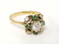 Lot 16 - An 18ct gold diamond and emerald cluster ring