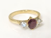 Lot 21 - A gold ruby and diamond three stone ring