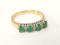 Lot 25 - An 18ct gold four stone emerald ring