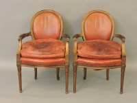 Lot 469 - A pair of 1920s red leather upholstered mahogany open elbow chairs