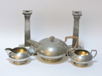 Lot 147 - A pair of Arts and Crafts pewter candlesticks