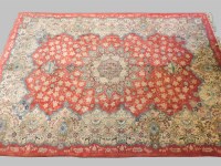 Lot 443 - A large Kashan red ground carpet