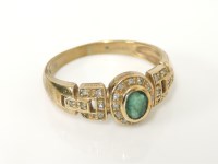 Lot 48 - A 9ct gold emerald and diamond oval cluster ring