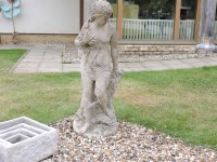 Lot 489 - A composite garden statue of semi clad maiden