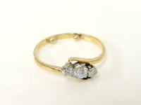 Lot 39 - A gold diamond three stone crossover ring