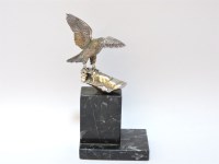 Lot 129 - A white metal sculpture of a hawk on a gloved hand