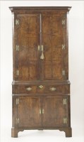 Lot 413 - A walnut and feather banded corner cupboard