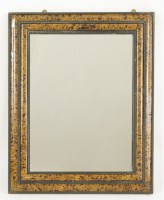 Lot 448 - A tortoiseshell and ebonised ripple moulded mirror