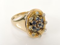 Lot 43 - A gold sapphire and diamond oval dispersed cluster ring