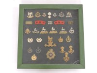 Lot 260A - A framed collection of military cap badges