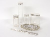 Lot 47 - Four silver topped dressing table jars